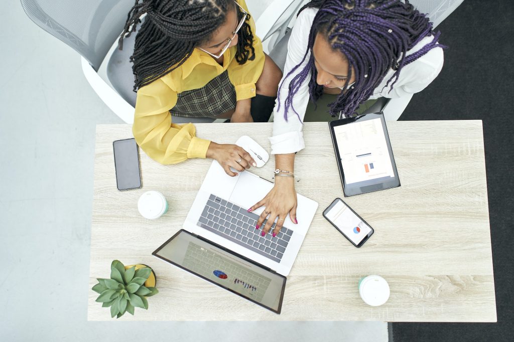 Top view of two young black women working in the office